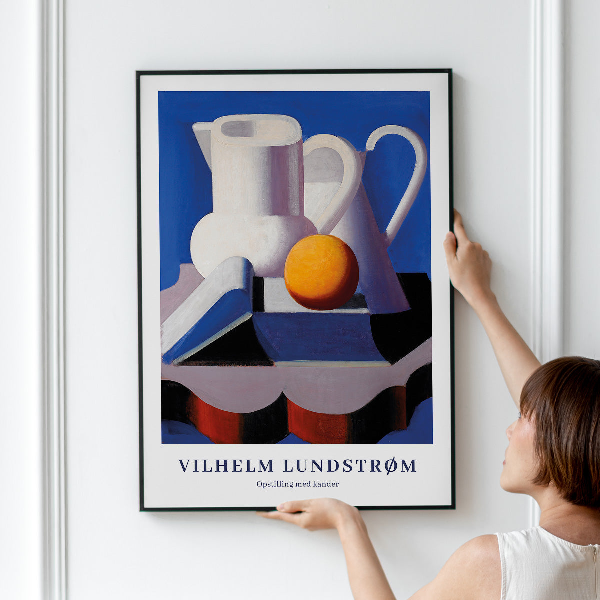 Plakat af Vilhelm Lundstrøm med titlen "Opstilling med kander" hænges op på en væg.