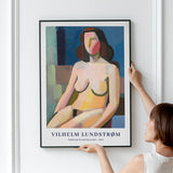 Plakat af Vilhelm Lundstrøm med titlen "Siddende kvindelig model - 1940" hænges op på en væg.