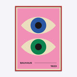 Plakat med to stiliserede øjne i blå og grøn på en lyserød baggrund, med teksten "BAUHAUS 1923" nederst.