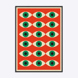 Plakat i sort træramme med et Bauhaus-inspireret design af gentagne øjenmotiver på en rød baggrund.