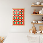 Plakat i træramme i køkken med Bauhaus-design, viser et mønster af grønne øjne på rød baggrund.