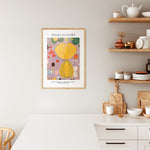 Plakat af Hilma af Klint med titlen "Adulthood" i træramme, hængende i et moderne køkken.