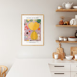 Plakat af Hilma af Klint med titlen "Adulthood" i træramme, hængende i et moderne køkken.