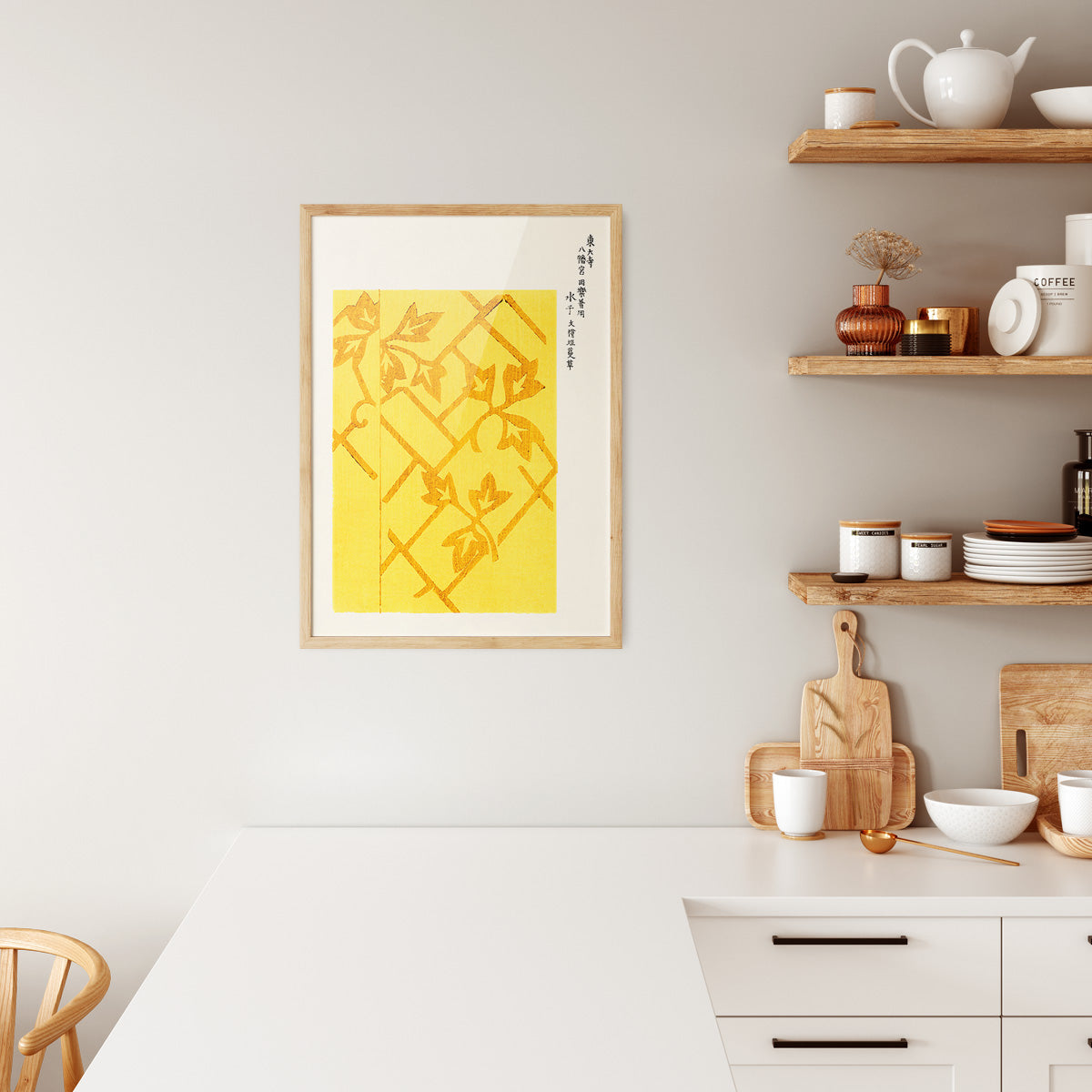 Plakat i træramme i køkken med gult design og japansk kalligrafi.
