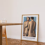 Plakat af Vilhelm Lundstrøm med titlen "To stående modeller - 1927" placeret på gulvet i en stue ved siden af et bord.