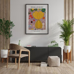 Plakat af Hilma af Klint med titlen "Adulthood" hænger på en væg i en moderne stueindretning med planter og minimalistiske møbler.