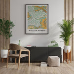 Plakat af William Morris hængende på en væg i en stilfuld stue med moderne møbler og grønne planter.