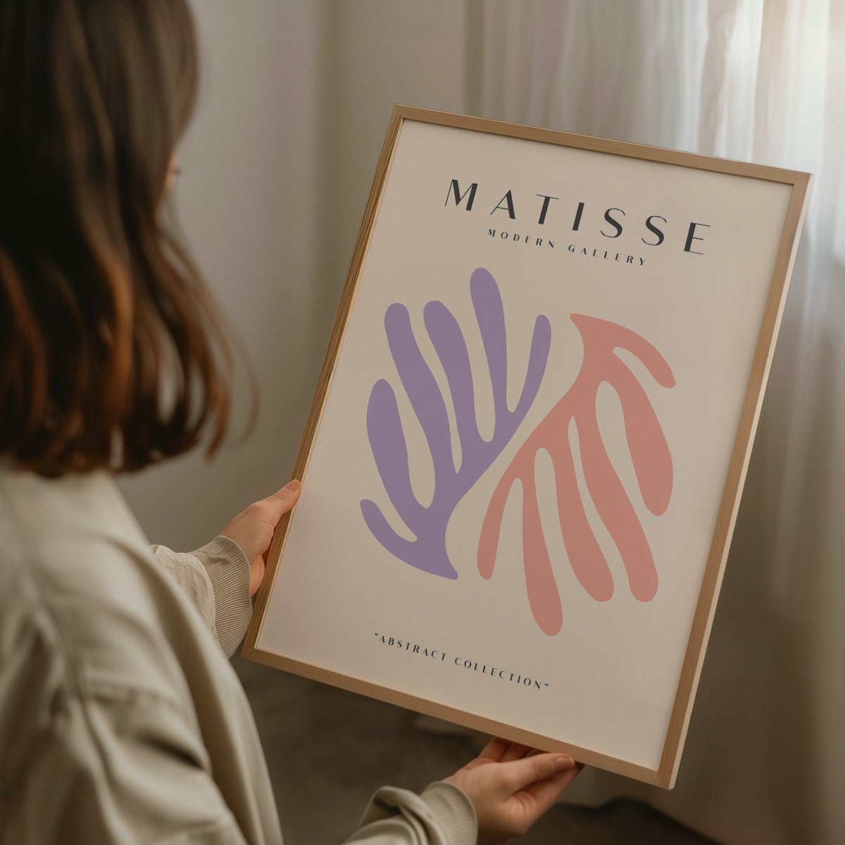Matisse Modern Gallery NO3 plakat i lys egetræsramme holdt af en person.